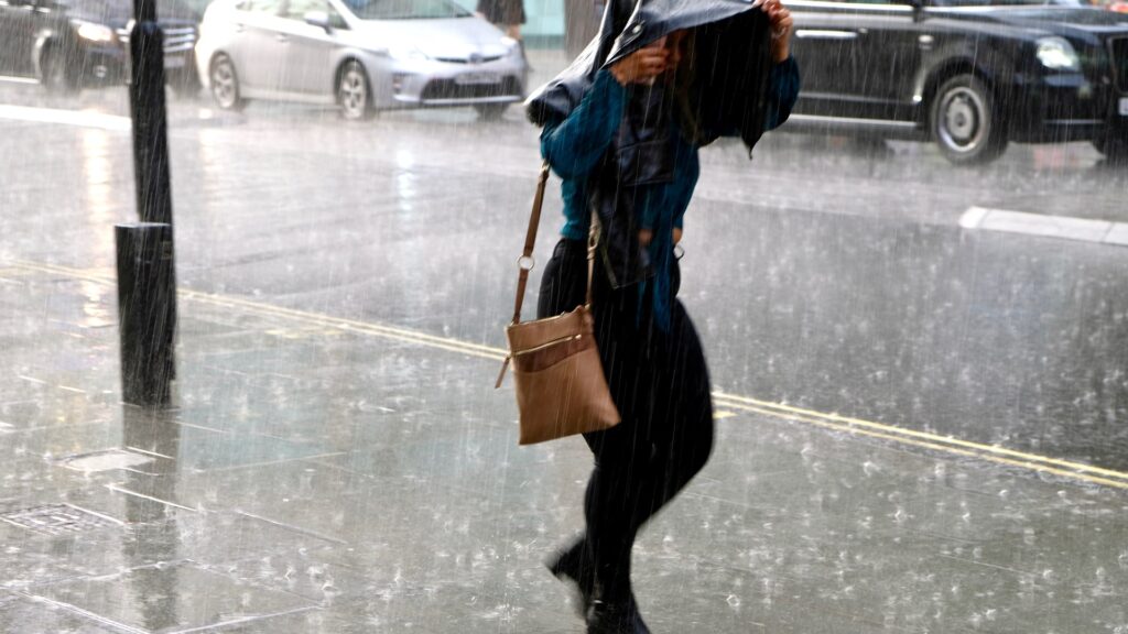 2021-woman-walking-oxford-street-981754881.jpg