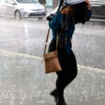 2021-woman-walking-oxford-street-981754881.jpg